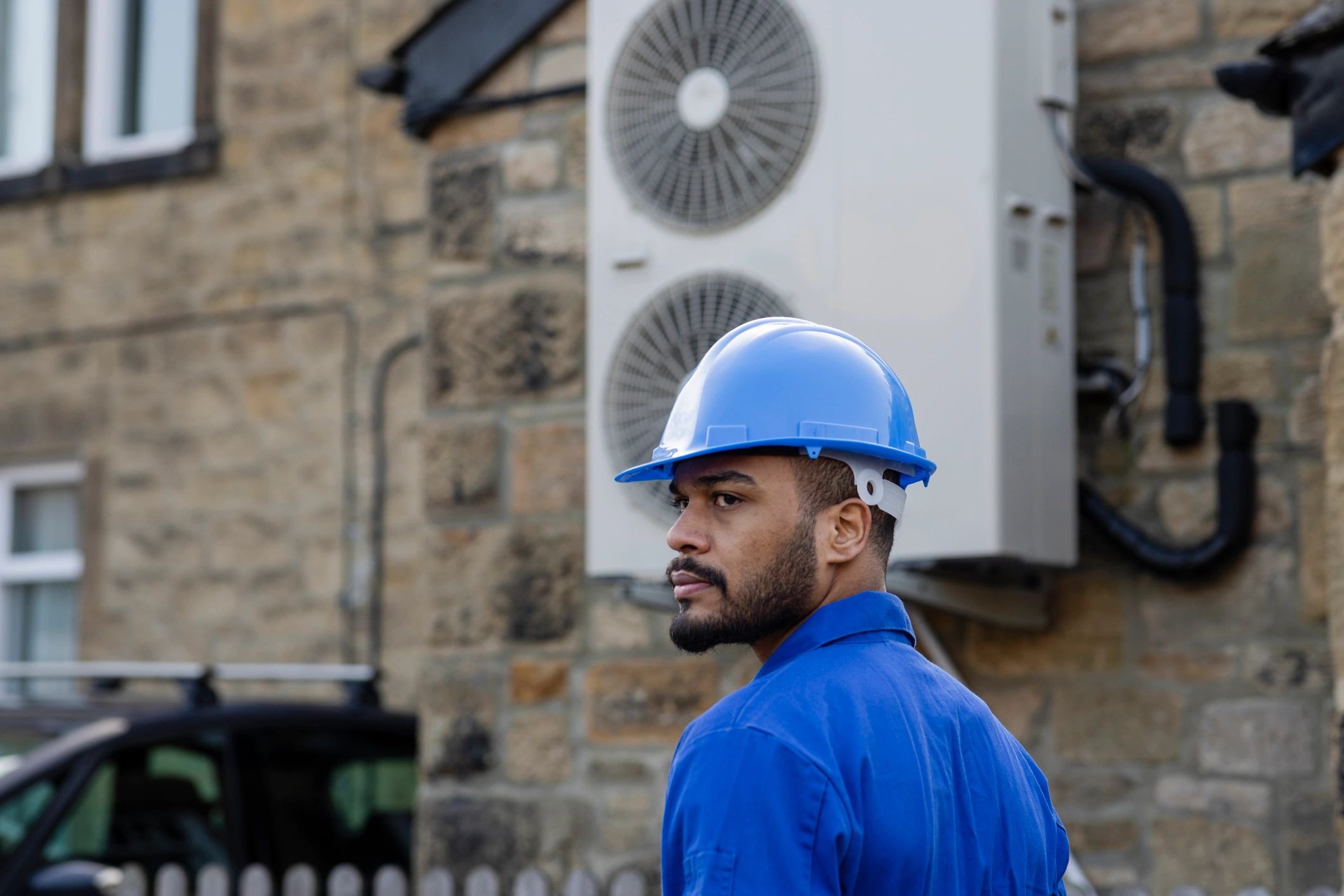 Technician installing or servicing home HVAC equipment