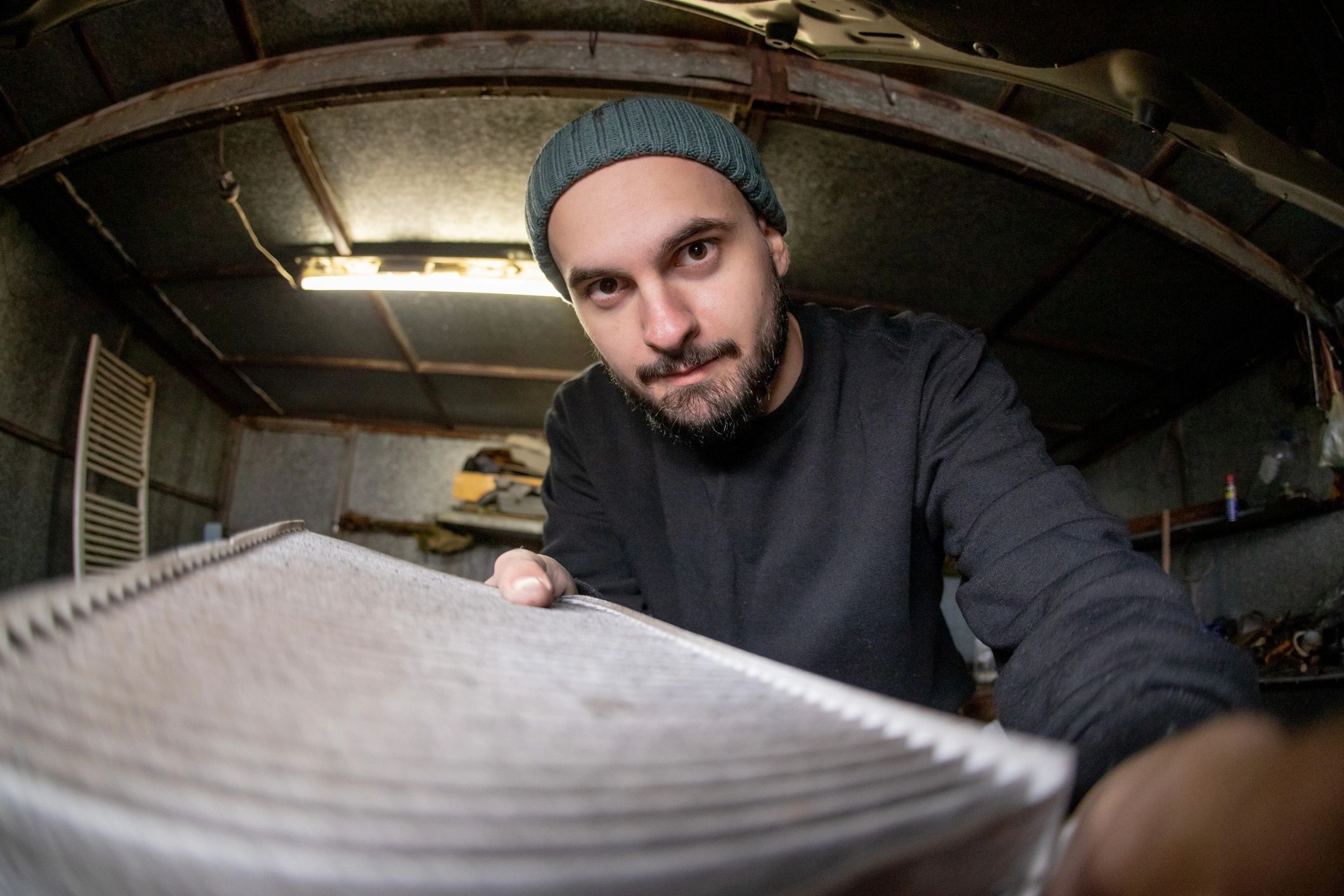 Technician servicing HVAC system during an emergency call