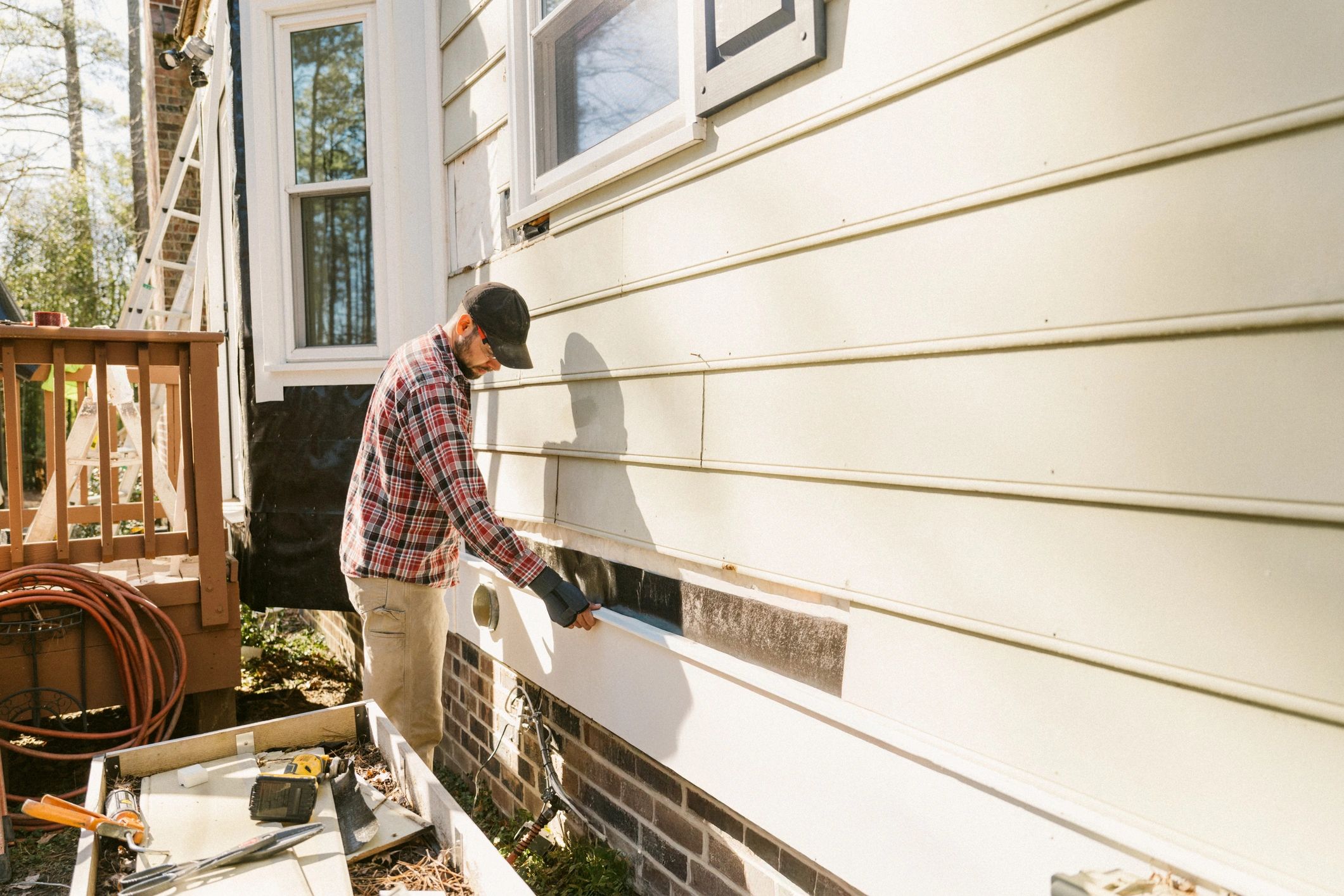 HVAC technician performing emergency repair on exterior home equipment