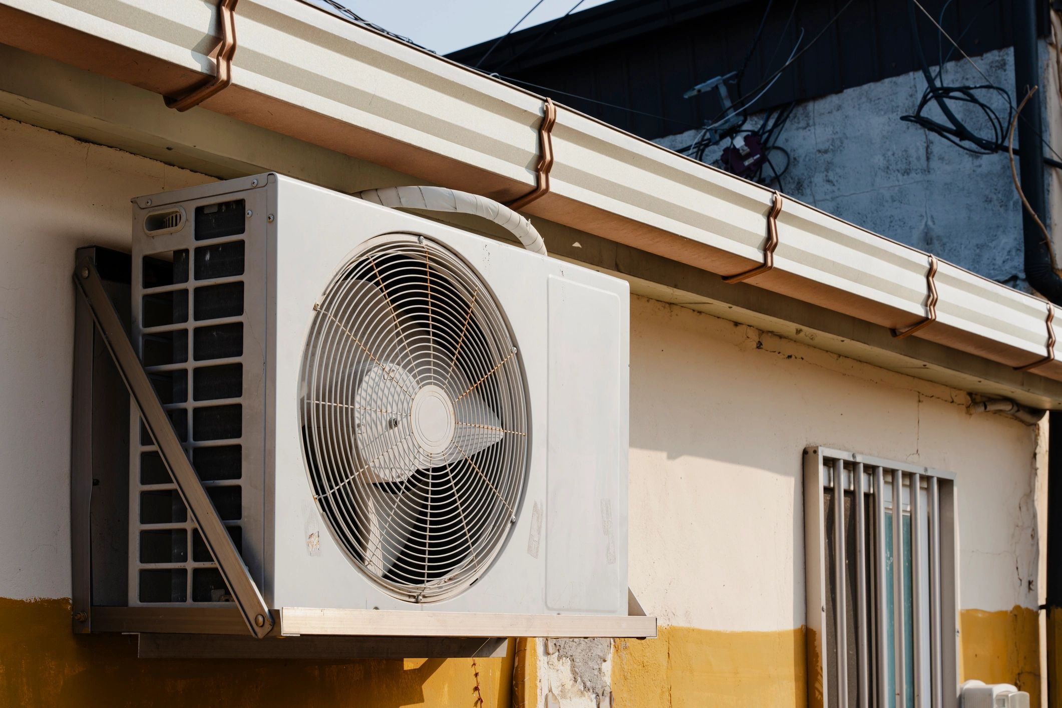 Mini split style air conditioning unit mounted on a building exterior