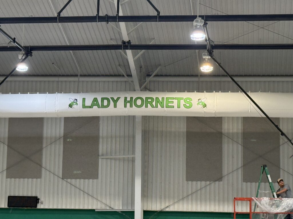 Large duct socks installed in a school gymnasium.