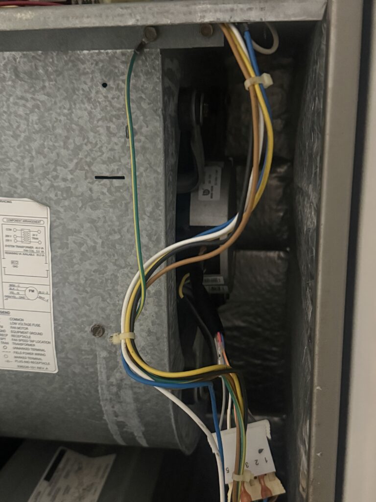 Blower motor being replaced on an old Carrier electric heater.