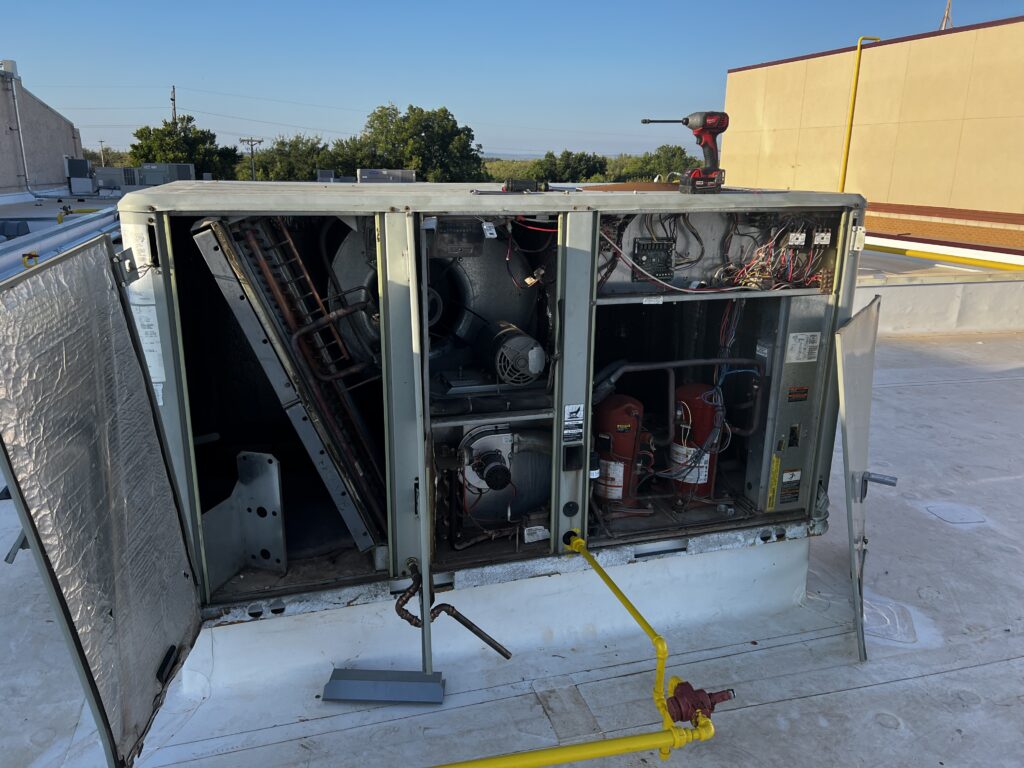Trane package unit being repaired on a commercial building